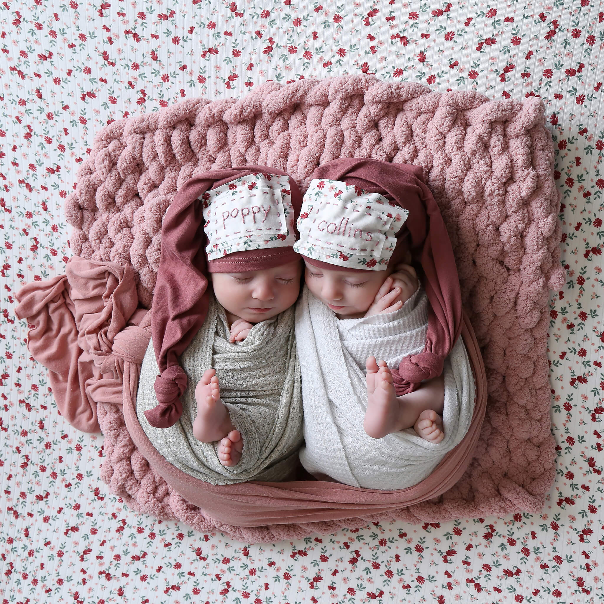 Photographer gently soothing newborn during session