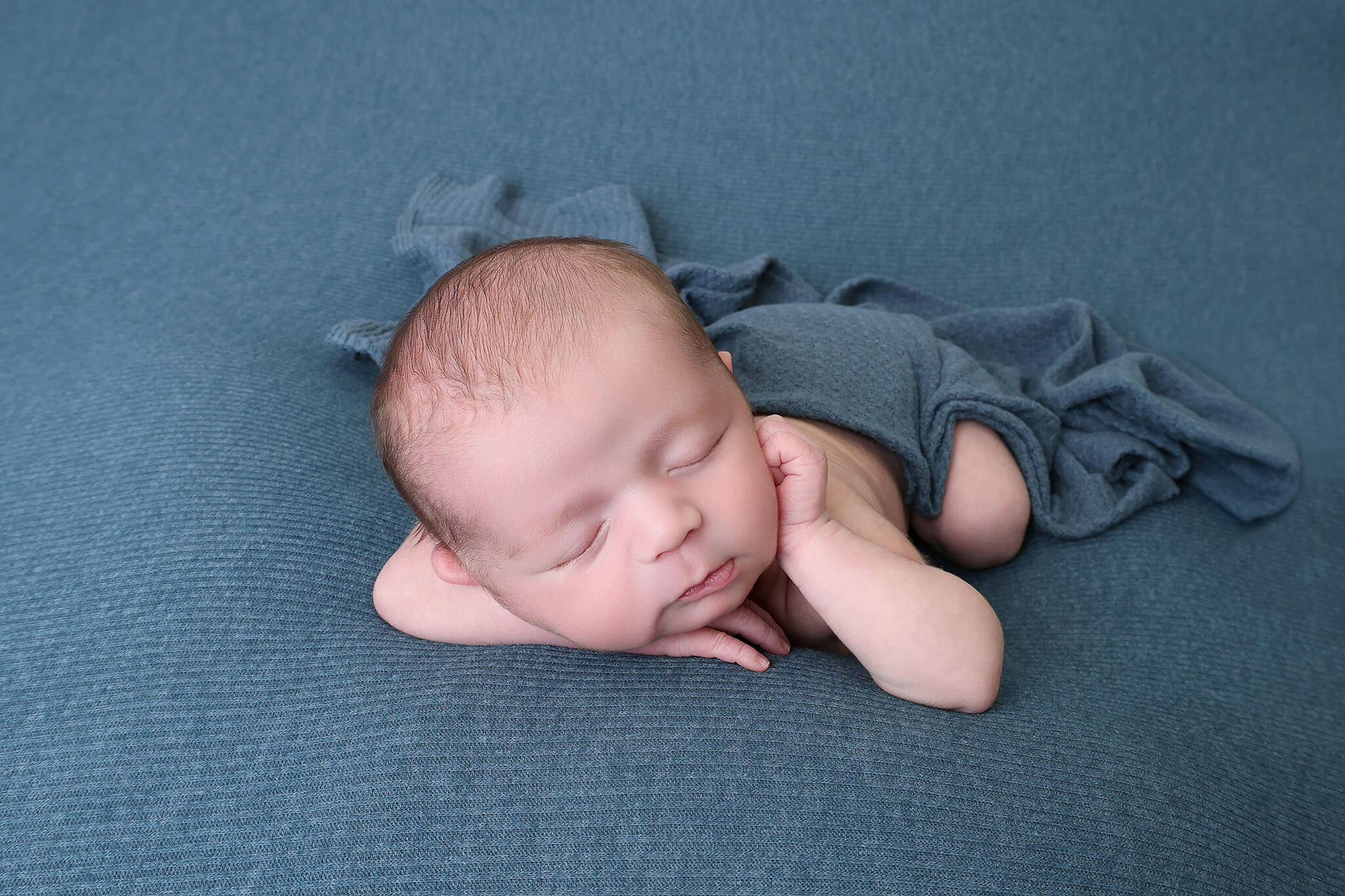 Wrapped newborn baby photographed in a Windsor CO newborn studio